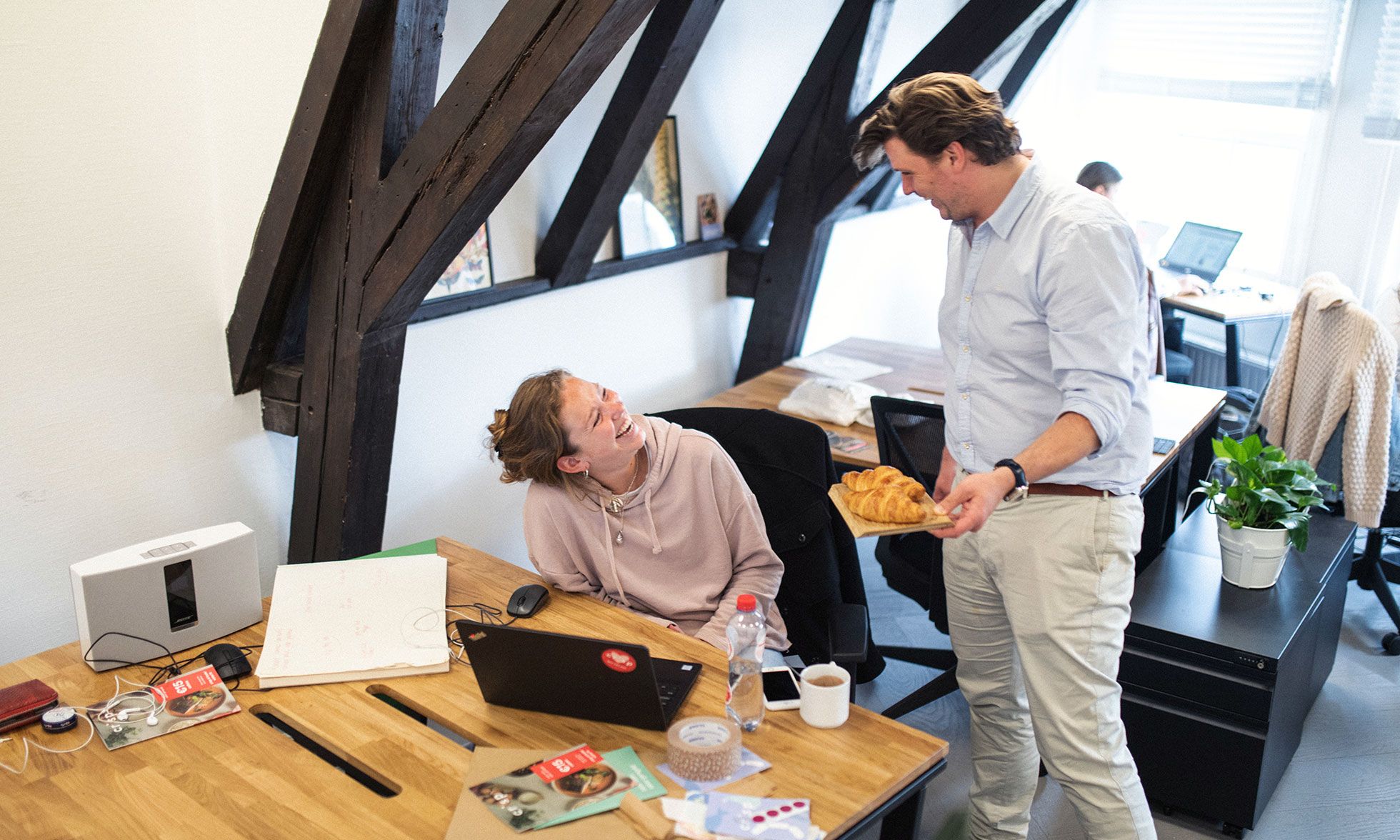 Crisp CFO Michiel Roodenburg and one of his colleagues laughing in their office